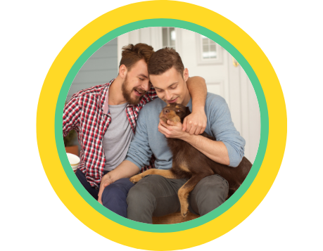Two men sitting together on a porch with a brown miniature pincher dog on their lap