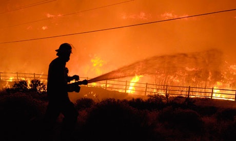 Photo of Firefighter fighting fire with hose