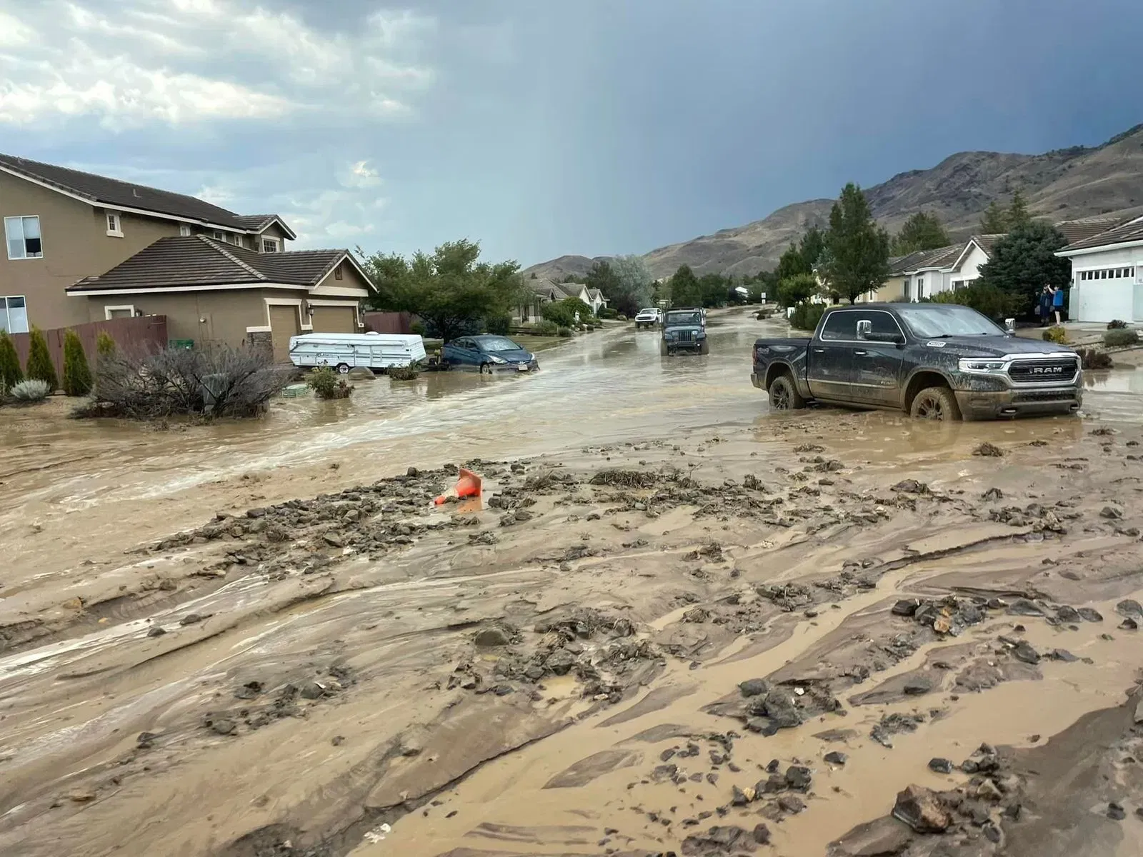 image of car driving through muddy and flooded street