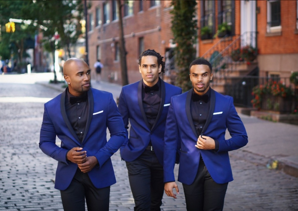 The members of Uptown walking down a street